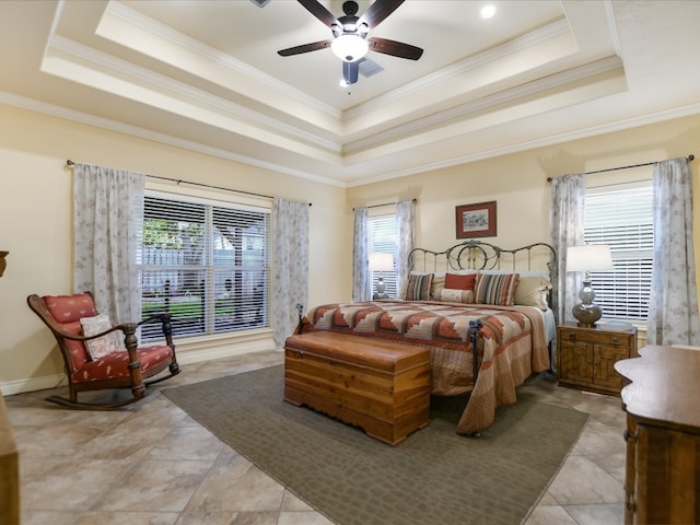 bedroom with a tray ceiling, ceiling fan, and ornamental molding