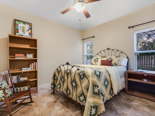 bedroom featuring multiple windows and ceiling fan