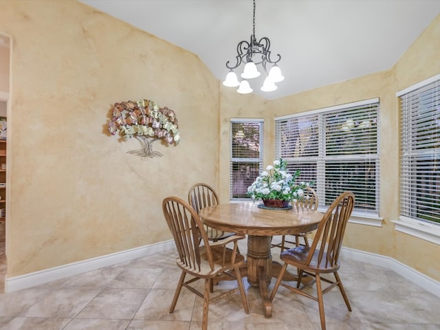 dining space with light tile patterned floors, vaulted ceiling, and an inviting chandelier