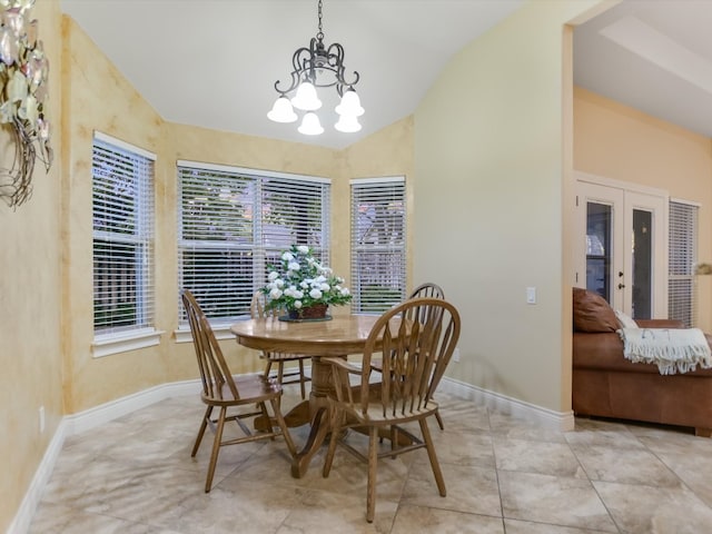 tiled dining room with vaulted ceiling and an inviting chandelier