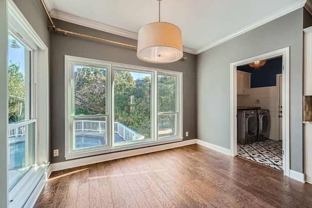 spare room featuring washing machine and dryer, crown molding, and hardwood / wood-style floors