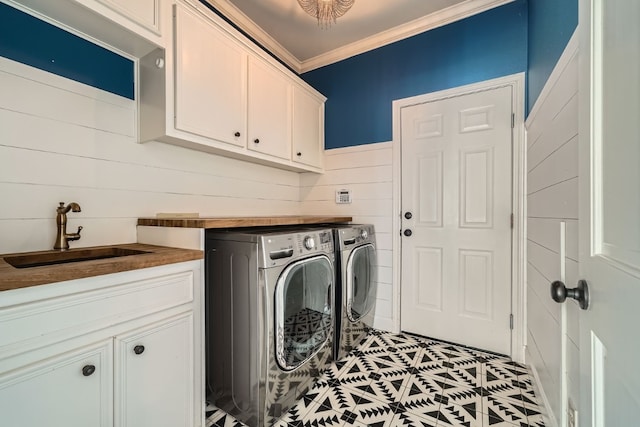 laundry room with washing machine and dryer, crown molding, sink, and cabinets