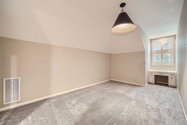 additional living space with light carpet and vaulted ceiling