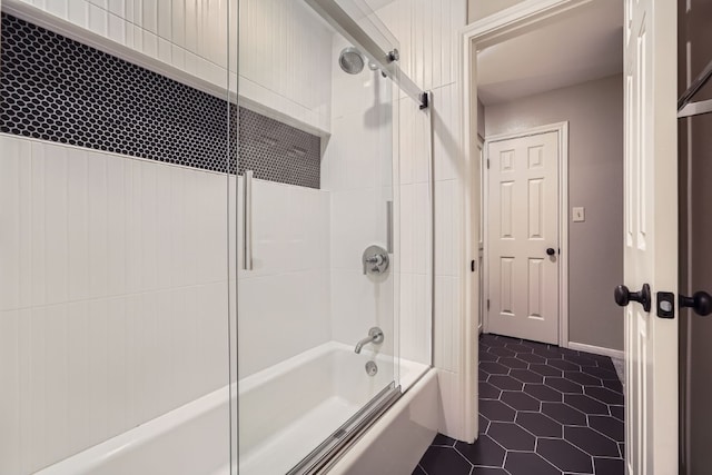 bathroom with tile patterned flooring and bath / shower combo with glass door