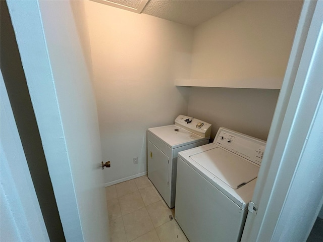 washroom with washer and dryer and light tile patterned flooring