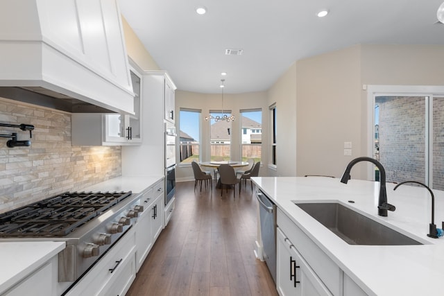 kitchen featuring premium range hood, white cabinetry, and sink