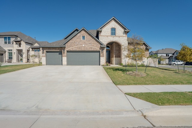 french country inspired facade featuring a garage and a front lawn