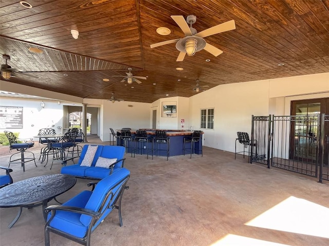 view of patio / terrace with a bar and a ceiling fan