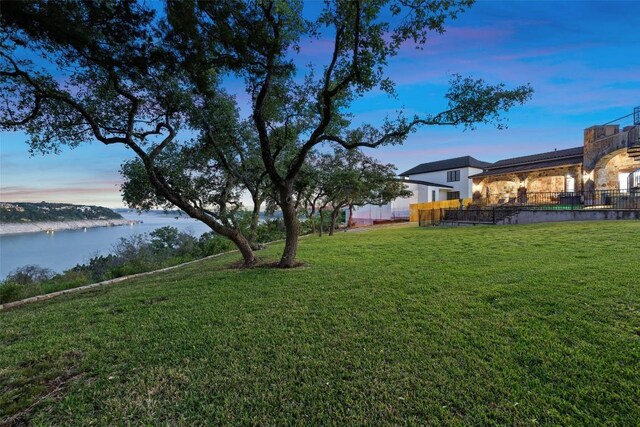 yard at dusk with a water view