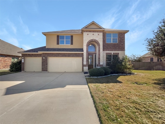 view of front of property featuring a front lawn and a garage