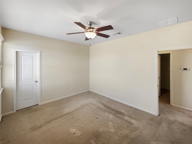 carpeted spare room with ceiling fan