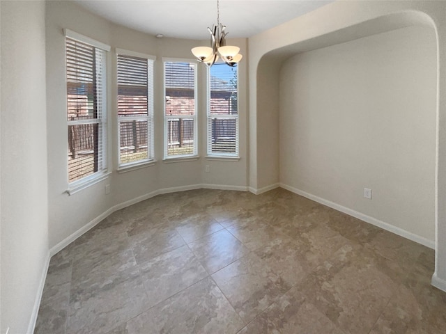 unfurnished dining area featuring a notable chandelier