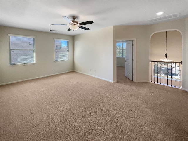 carpeted empty room featuring ceiling fan