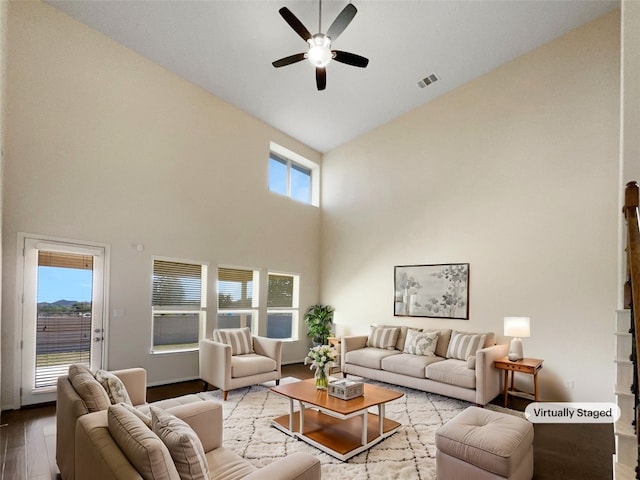 living room with light wood-type flooring, high vaulted ceiling, and ceiling fan