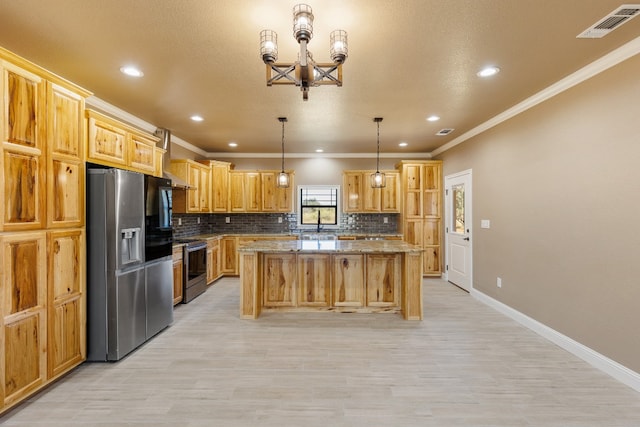 kitchen with light stone counters, ornamental molding, stainless steel appliances, a kitchen island, and hanging light fixtures