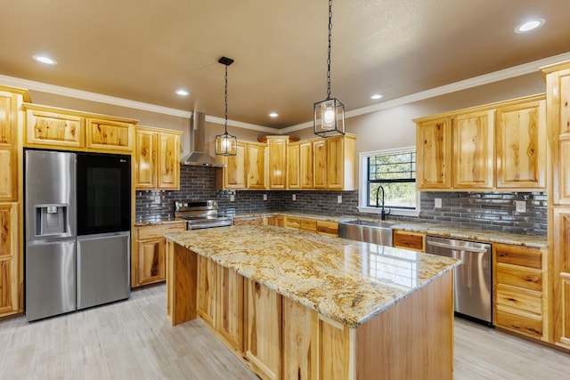 kitchen featuring light stone counters, stainless steel appliances, sink, wall chimney range hood, and a center island