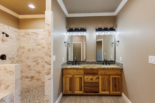 bathroom featuring hardwood / wood-style flooring, ornamental molding, and tiled shower