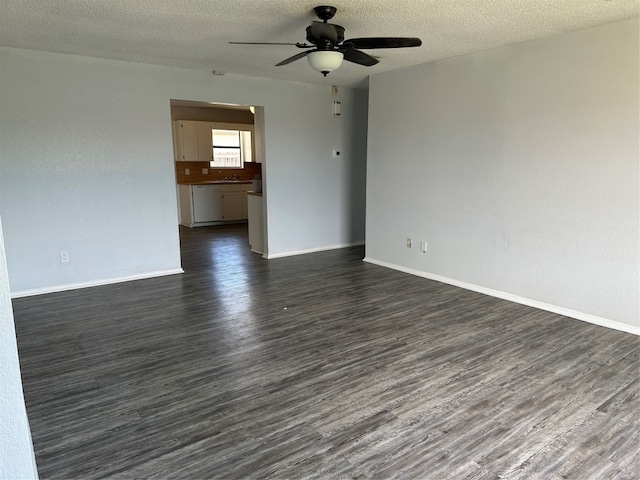 spare room featuring a textured ceiling, ceiling fan, sink, and dark hardwood / wood-style floors