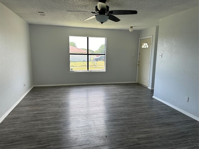 spare room featuring a textured ceiling, dark hardwood / wood-style floors, and ceiling fan