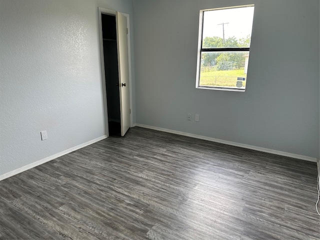 unfurnished bedroom featuring dark wood-type flooring