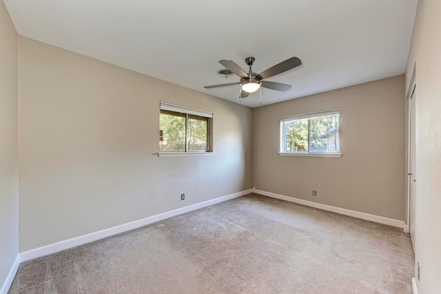 empty room with light colored carpet and ceiling fan