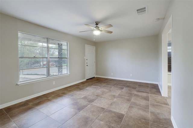 tiled empty room with ceiling fan