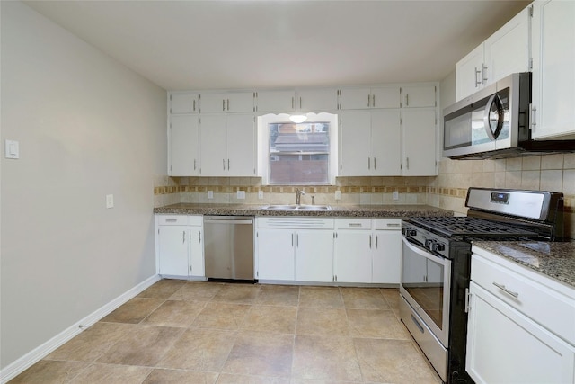 kitchen featuring decorative backsplash, stainless steel appliances, sink, stone counters, and white cabinets