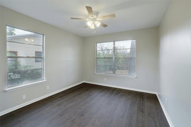 spare room with dark hardwood / wood-style floors and ceiling fan