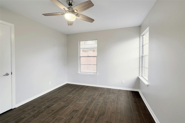 spare room with ceiling fan and dark hardwood / wood-style flooring