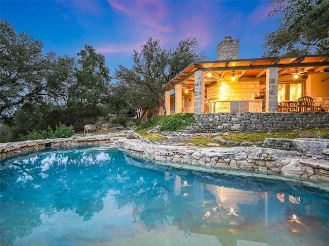 view of pool at dusk