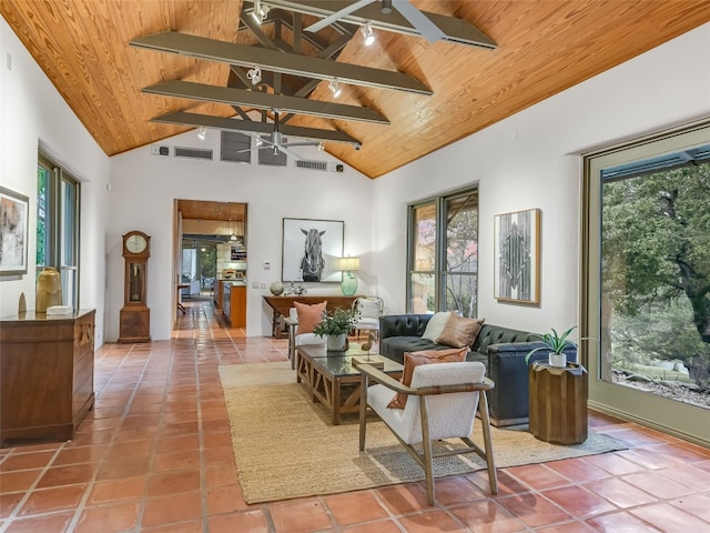 interior space with ceiling fan, beamed ceiling, wood ceiling, and high vaulted ceiling