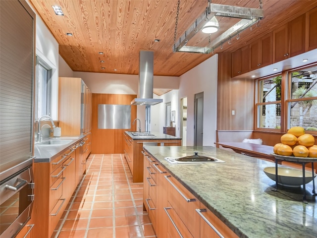 kitchen featuring stone countertops, island range hood, wooden ceiling, and sink