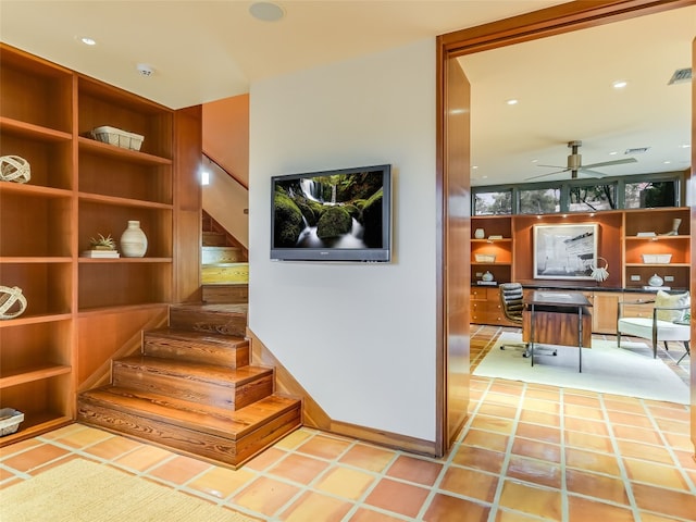 stairs featuring ceiling fan and tile patterned flooring