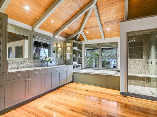 bathroom with wood ceiling, vaulted ceiling with beams, a healthy amount of sunlight, and wood-type flooring