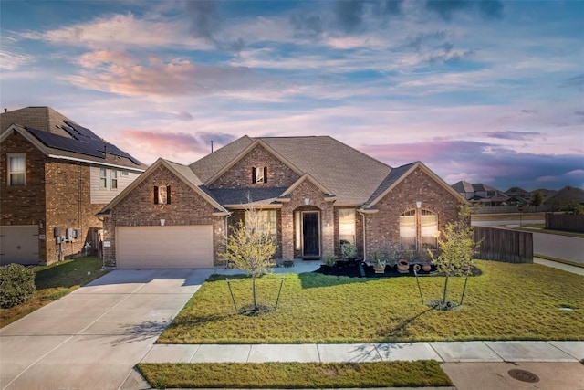 19316 Chayton Cir, Pflugerville, TX 78660 - traditional home with concrete driveway, a front yard, a garage, brick siding, and roof with shingles