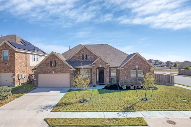 19316 Chayton Cir, Pflugerville, TX 78660 - traditional-style home with concrete driveway, brick siding, a garage, and a shingled roof