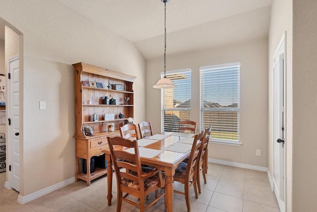 19316 Chayton Cir, Pflugerville, TX 78660 - dining space with lofted ceiling, light tile patterned floors, baseboards, and arched walkways
