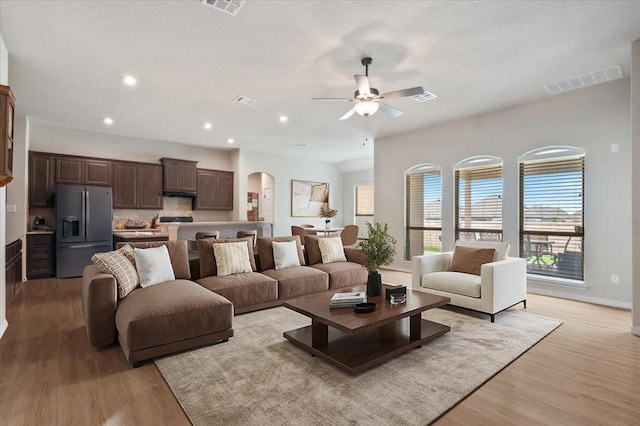 19316 Chayton Cir, Pflugerville, TX 78660 - living area featuring a ceiling fan, arched walkways, healthy amount of natural light, light wood-type flooring, and recessed lighting