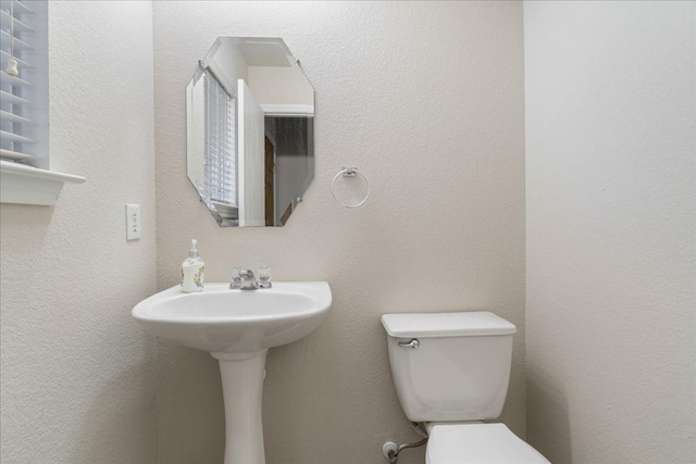 bathroom with toilet and sink