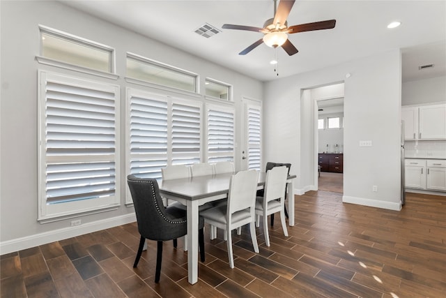 dining room with ceiling fan and dark hardwood / wood-style flooring