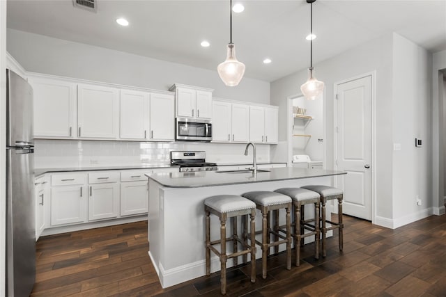 kitchen with sink, white cabinets, and stainless steel appliances