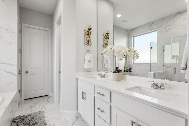 bathroom featuring vanity and shower with separate bathtub