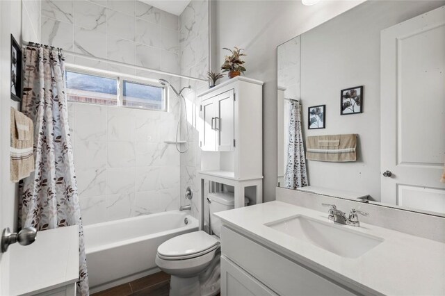 full bathroom featuring toilet, vanity, and shower / tub combo