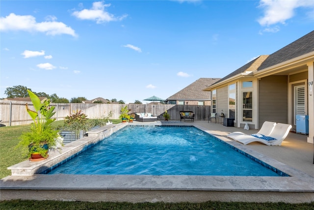 view of pool featuring pool water feature, a patio, and an outdoor hangout area