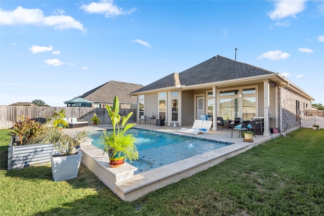 view of pool with a lawn, an outdoor hangout area, and a patio