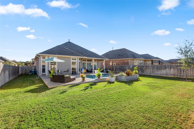 rear view of house with outdoor lounge area, a yard, and a patio