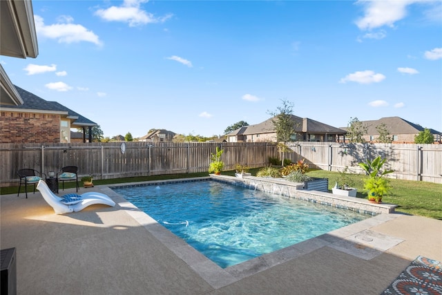 view of swimming pool with pool water feature and a patio