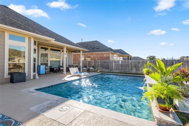 view of pool featuring pool water feature and a patio