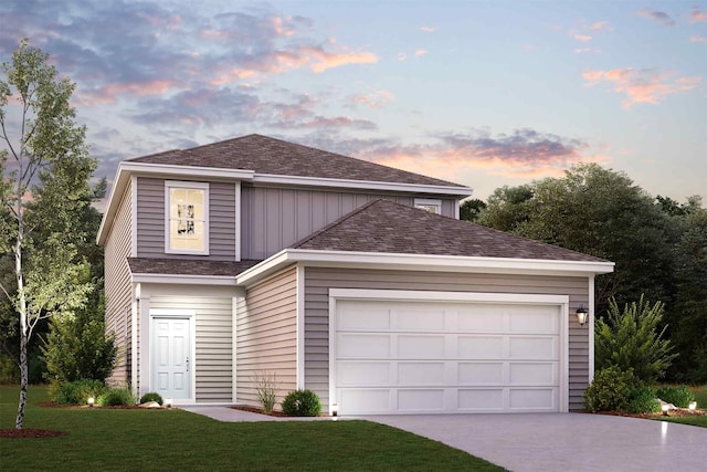 view of front of property featuring a garage and a lawn