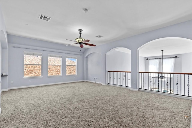 spare room featuring ceiling fan and carpet